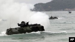 Amphibious assault vehicles prepare to hit the ground at a join military exercise, 'Cobra Gold' on Hat Yao beach in Chonburi province eastern, Thailand, February 10, 2012. 