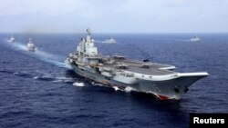 China's aircraft carrier Liaoning takes part in a military drill of Chinese People's Liberation Army (PLA) Navy in the western Pacific Ocean, April 18, 2018. 