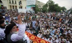Khadim Hussain Rizvi, leader of Tehrik-e-Labaik Pakistan (TLP) Islamic political party, gestures as he addresses supporters during a rally to express solidarity with the people of Kashmir, in Lahore, Pakistan, Aug. 9, 2019.
