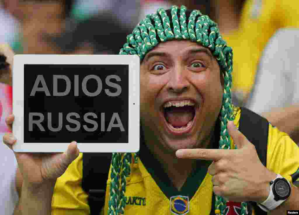 A spectator holds up a message for Russia before the start of the 2014 World Cup Group H soccer match against Belgium at Maracana stadium in Rio de Janeiro, Brazil.