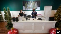 Balsam Hill Outlet sales associate Rickey Haynes, right, listens to manager Kelly Bratt during training in Allen, Texas, Monday, Sept. 20, 2021. Employers are dealing 