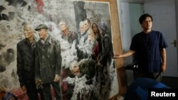 The head of the Mansudae Art Museum Ji Zhengtai talks about a painting by a North Korean artist in the studio of the gallery in the 798 art district in Beijing, China, September 20, 2017. (Reuters) 