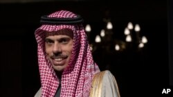 FILE - Saudi Arabia's Foreign Minister Prince Faisal bin Farhan looks on as he stands next to his Greek Counterpart Nikos Dendias before their meeting in Athens, Jan. 24, 2020. 