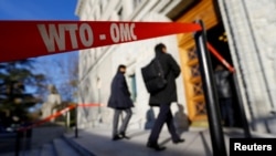 FILE - Delegates arrive at the World Trade Organization (WTO) headquarters in Geneva, Switzerland, Nov. 22, 2017.