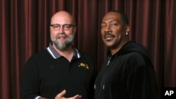 Eddie Murphy, right, star of the film "Dolemite Is My Name," poses with director Craig Brewer at the Shangri-La Hotel during the Toronto International Film Festival in Toronto, Sept. 7, 2019. 