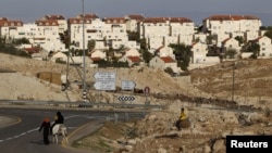 FILE - Bedouins ride donkeys in the West Bank near Jerusalem, Dec. 3, 2012. 