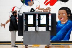 A voter casts a ballot during Georgia's Senate runoff elections, in Atlanta, Jan. 5, 2021.