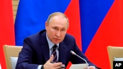 Russian President Vladimir Putin speaks as he chairs a meeting on drafting constitutional changes at the Novo-Ogaryovo residence outside Moscow, Jan. 16, 2020. 