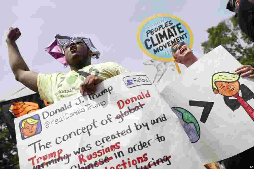 A pair of participants chant in front of the White House in Washington, April 29, 2017, during a demonstration and march. Thousands of people gathered across the country to march in protest of President Donald Trump&#39;s environmental policies, which have included rolling back restrictions on mining, oil drilling and greenhouse gas emissions at coal-fired power plants.