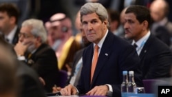 FILE - U.S. Secretary of State John Kerry attends the "Supporting Syria and the Region" conference in London, Feb. 4, 2016. Kerry said Sunday the "path to peace" in Syria is "actually right in front of us now." 