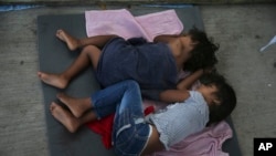  Migrant children sleep on the floor of a shelter in Nuevo Laredo, Mexico, July 17, 2019. Asylum-seekers grappled to understand a new U.S. policy that all but eliminates refugee claims by Central Americans and many others.