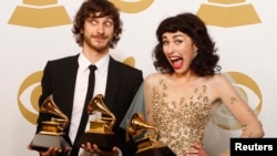 Gotye poses with his Grammy awards for Best Pop Duo/Group Performance with Kimbra (R) and for Best Alternative Music Album, backstage at the 55th annual Grammy Awards in Los Angeles, California Feb. 10, 2013. 