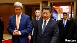 Menteri Luar Negeri John Kerry (kiri) dan Presiden China Xi Jinping dalam pertemuan kerjasama AS-China di Beijing (9/7). 