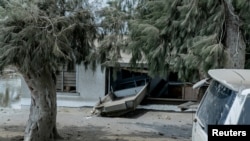 A general view shows damaged buildings and landscape covered with ash following the volcanic eruption and tsunami in Tongatapu, Tonga, January 16, 2022 in this picture obtained from social media.