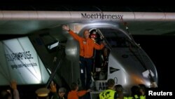 Swiss pilots Bertrand Piccard waves his hand before Solar Impulse 2 takes off at Mandalay international airport, Myanmar, March 30, 2015. 