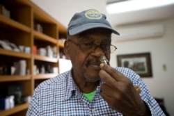 Pierre Leger smells a perfume at the Frager's vetiver factory, in Les Cayes, Haiti.