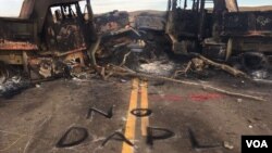 FILE - "No DAPL," or Dakota Access pipeline, is spray painted across the site of a protest flare up in North Dakota. (J. Patinkin/VOA)