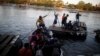 FILE - People belonging to a caravan of migrants from Honduras en route to the United States cross the Suchiate River to Mexico from Tecun Uman, Guatemala, Jan. 18, 2019. 