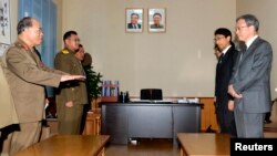 A combination of pictures shows U.S. President Barack Obama and German Chancellor Angela Merkel as they try the virtual reality device PMD during the opening tour of the Hannover Messe in Hanover, Germany.