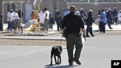 FILE - Inmates are seen exercising in the main yard at the California State Prison in Vacaville, California, May 20, 2015.