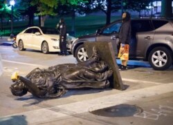 Wisconsin's 'Forward' statue lies in the street on Capitol Square in Madison, Wis., June 23, 2020.