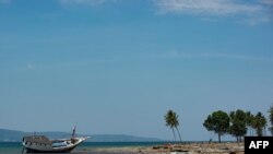 A stranded boat is seen on the coast of Central Sulawesi, Indonesia, Oct. 3, 2018, after an earthquake. A 7.1 magnitude temblor hit nearby North Maluku province Thursday.
