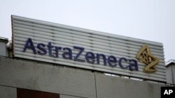 FILE - The AstraZeneca logo is shown on the company's building in Shanghai, China.