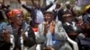 Seated left to right, Kenyans Jane Muthoni Mara, Wambogo Nyingi and Paulo Muoka Nzili celebrate the announcement of a legal decision in support of Mau Mau veteran reparation payments in Nairobi in this October 5, 2012, file photo.