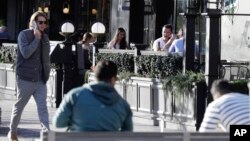 People sit in an outdoor restaurant area in Christchurch, New Zealand, Monday, June 8, 2020. New Zealand appears to have completely eradicated the coronavirus, at least for now. (AP Photo/Mark Baker)