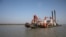 FILE - A dredging machine is seen near the island of Bhasan Char, in the Bay of Bengal, Bangladesh. Feb. 14, 2018. 