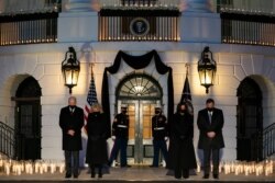 President Joe Biden, first lady Jill Biden, Vice President Kamala Harris, and Doug Emhoff participate in a moment of silence during a ceremony to honor the 500,000 Americans that died from COVID-19, at the White House, Feb. 22, 2021.