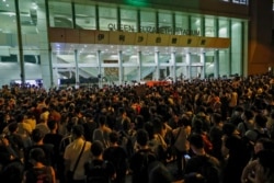 Protesters gather outside Queen Elizabeth Stadium in Hong Kong, Sept. 26, 2019, chanting slogans outside the venue as embattled leader Carrie Lam began a town hall session aimed at cooling down months of pro-democracy demonstrations.