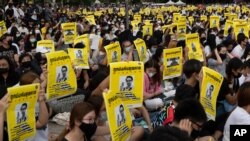 Pro-democracy students hold posters of a missing Thai activist during a protest at the Thammasat University in Pathum Thani, north of Bangkok, Thailand, Aug, 10, 2020.