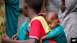 FILE - In this photo taken March 26, 2020, residents live in crowded conditions in the Sayidka camp for internally displaced people in Mogadishu, Somalia. 