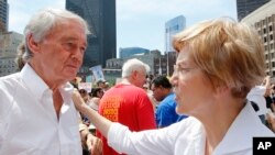 Sen. Ed Markey, D-Mass., left, talks with Sen. Elizabeth Warren, D-Mass. during the Rally Against Separation Saturday, June 30, 2018, in . (AP Photo/Winslow Townson)