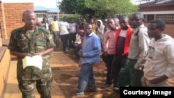 Volunteers queue for new non-surgical male circumcision procedure in Rwanda. (Courtesy Rwandan Dept. of Defense) 