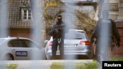 FILE - Members of the German special police force stand guard outside a building in Germany, Dec. 15, 2015.