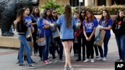 FILE - High school students visit UCLA in 2015. Most colleges permitted visitors this year. (AP Photo/Damian Dovarganes, File)