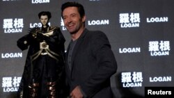 Actor Hugh Jackman poses with a cloth puppet, a traditional type of opera during a news conference during the Asian premiere of the X-Men series film 'Logan' in Taipei, Taiwan, Feb. 28, 2017. 