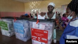 A voter casts her ballot during Liberia's presidential and legislative election in Monrovia on Oct. 10, 2023.