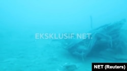 FILE - Debris, believed to be from Lion Air flight JT610 plane, which crashed, is seen during an operation by Navy divers near the search area off Tanjung Pakis, Indonesia, Oct. 31, 2018, in this still image taken from a video obtained from social media. 