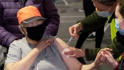 Annie Sting receives a vaccine at a mobile coronavirus disease (COVID-19) vaccine clinic for members of the deaf and blind community, organized by Swedish Medical Center in Seattle, Washington, U.S., March 19, 2021.