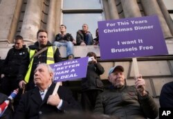 Demonstrators hold placards at the "Brexit Betrayal Rally," a pro-Brexit rally, on Park Lane in London, Dec, 9, 2018.