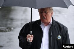 U.S. President Donald Trump talks to reporters from the White House in Washington, October 15, 2018 before leaving for Florida to inspect hurricane damage there.