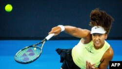 TOPSHOT - Japan's Naomi Osaka serves against Germany's Tamara Korpatsch during their women's singles match at the Brisbane International tennis tournament in Brisbane on Jan. 1, 2024. 