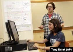 Coach J Collins watches Kaila Morris play "Heroes of the Storm," at Hathaway Brown School, Wednesday, July 10, 2019, in Shaker Heights, Ohio.