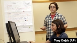 Coach J Collins watches Kaila Morris play "Heroes of the Storm," at Hathaway Brown School, Wednesday, July 10, 2019, in Shaker Heights, Ohio.