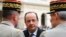 France's President Francois Hollande (C) speaks to military officials as he attends a ceremony to the memory of Stephane Hessel, at the Invalides in Paris, March 7, 2013.