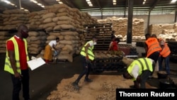 FILE - Cashew nut warehouse operations during COVID-19 in Abidjan, Ivory Coast. 