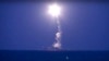 FILE - In this photo made from the footage taken from Russian Defense Ministry official website, a Russian navy ship on the Caspian Sea launches a cruise missile toward Islamic State targets in Syria, the ministry said, Oct. 7, 2015.